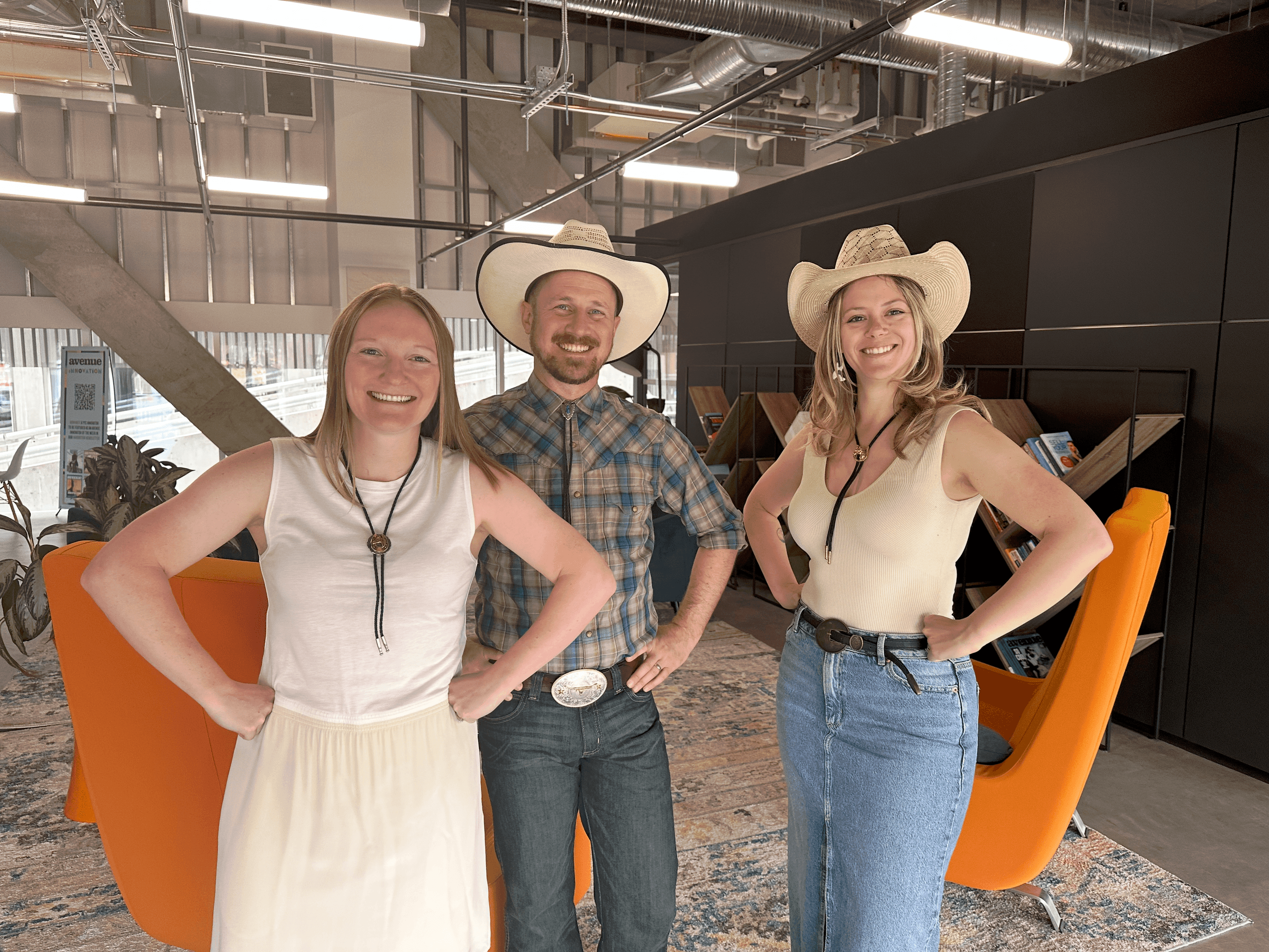 Three urllo team members (Jaime Minerson, VP Operations, Matt Hayles, VP Revenue, and Shannon Young, Customer Success Manager) smiling and dressed in cowboy hats and Western attire.