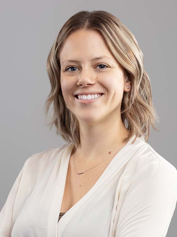 Image of two people at a desk looking at a computer.