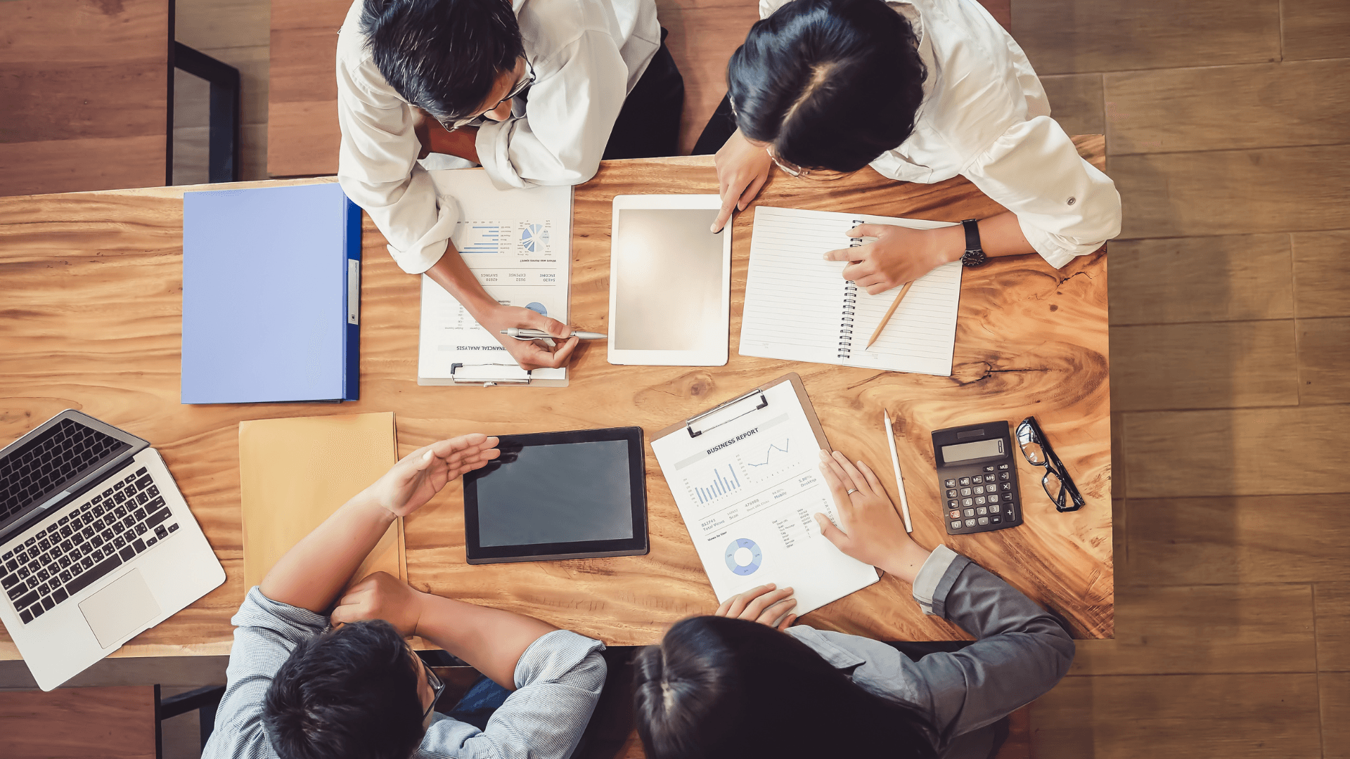 Image of people at an office collaborating on a project.